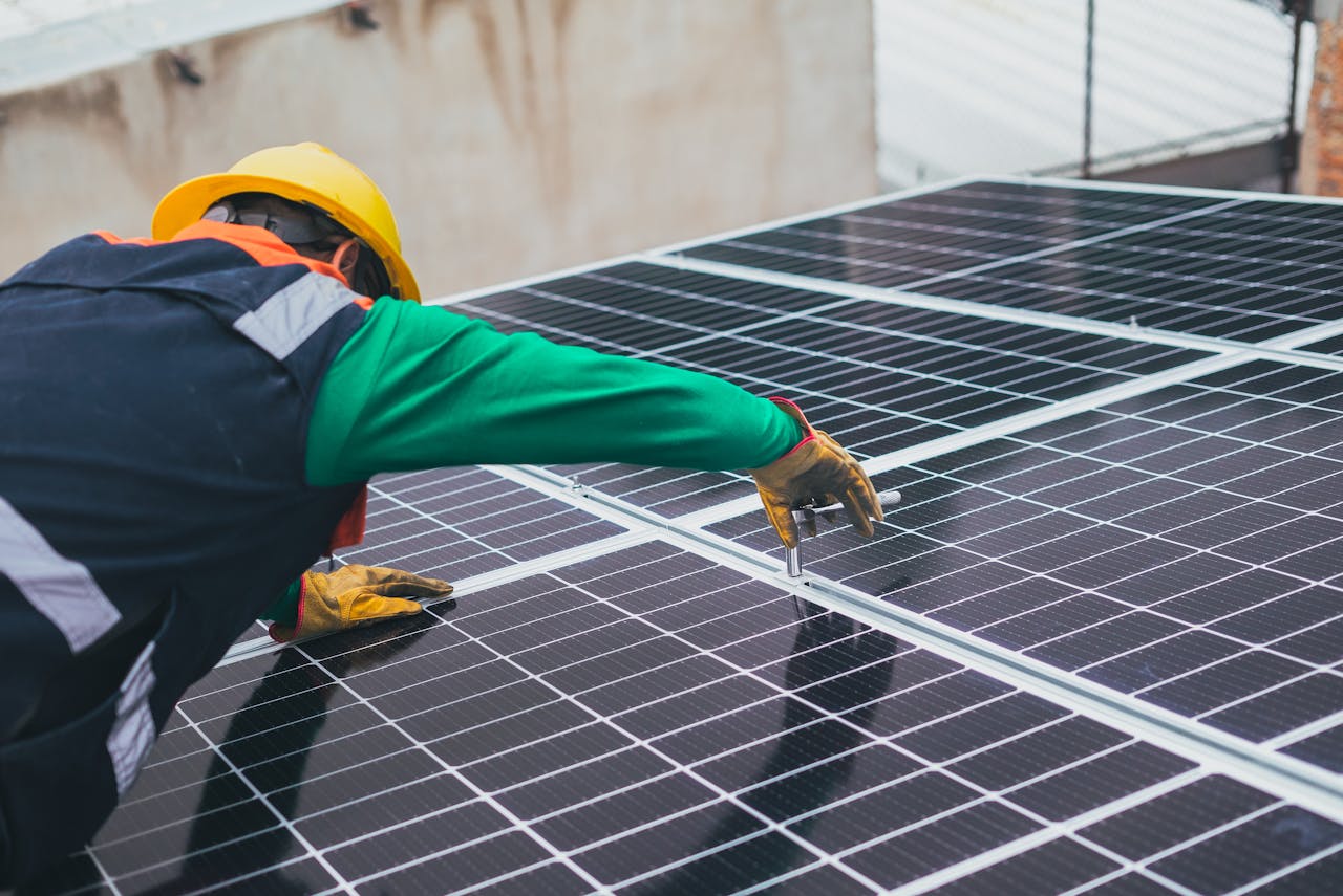 services-04 Technician installing solar panels on a rooftop for sustainable energy solutions.